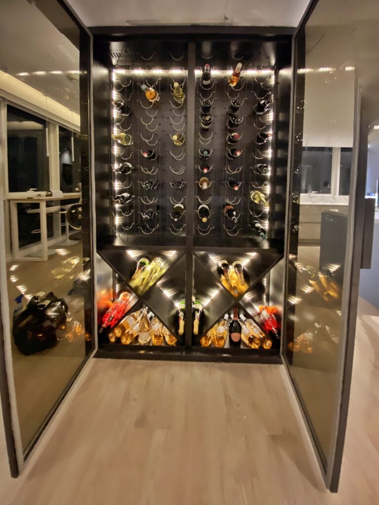 Blackened steel wine cabinet with mirror-polished stainless side panels