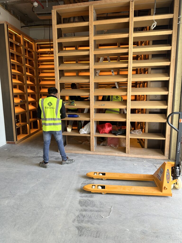 Fabricated racking being positioned during installation