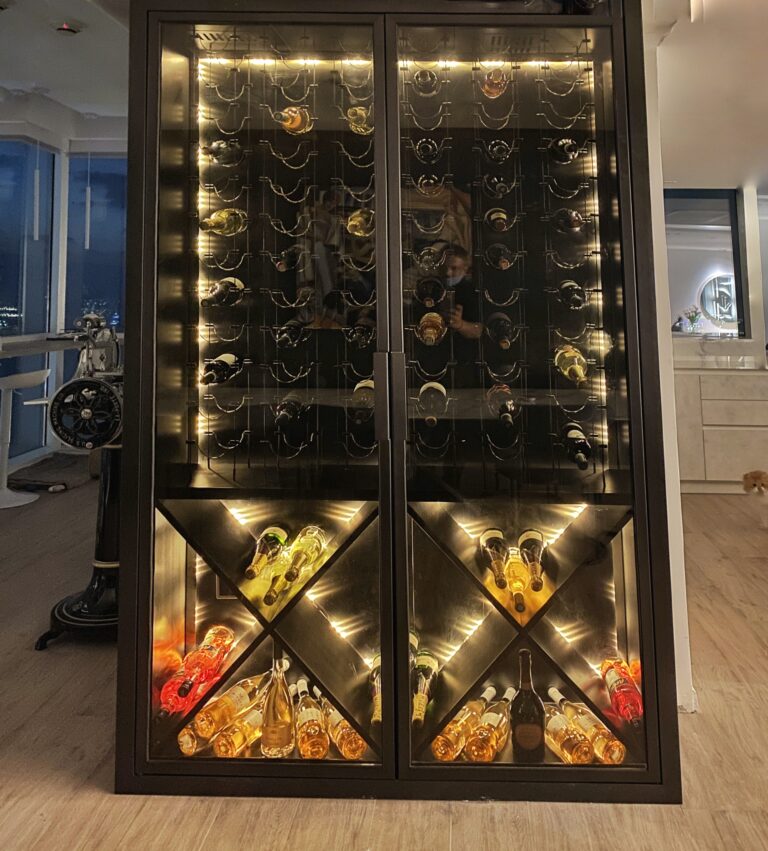 Bronze-framed glazed wine display cabinet with brass diamond bin racking