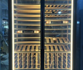 Bespoke black-framed wine display cabinet with mixed wood racking and LED edge lighting by BartechCo