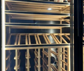 Interior detail of wine cabinet showing solid wood display shelves and single-bottle racking
