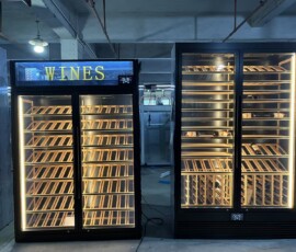 Two bespoke wine display cabinets by BartechCo, illuminated WINES signage unit and mixed wood racking unit